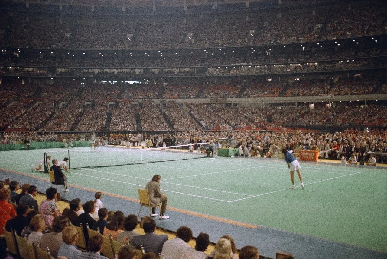 Indoor tennis game with audience watching