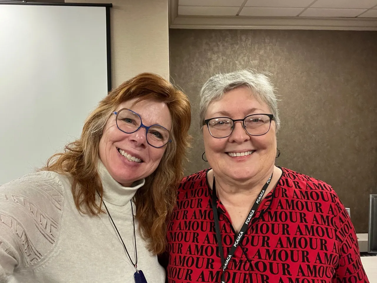 Two women smiling together indoors