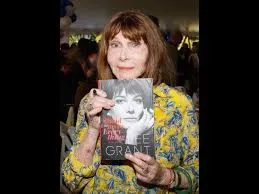 Woman holding a book at an event