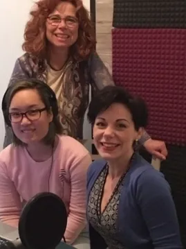 Smiling women in a podcast setup