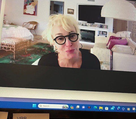 Person with glasses on computer screen