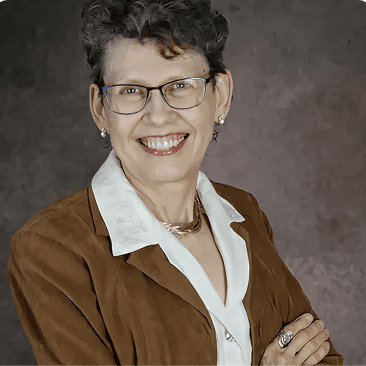 Professional woman with short hair and glasses