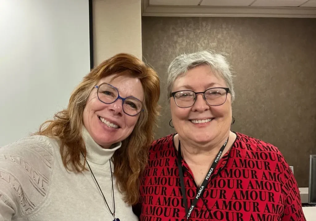 Two women smiling together indoors
