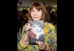 Woman holding a book at an event