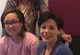 Smiling women in a podcast setup