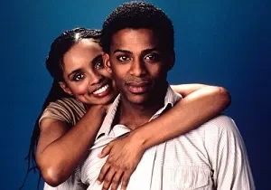 Smiling couple embracing against blue background