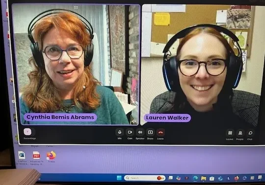 Two women in a video call on laptop screens